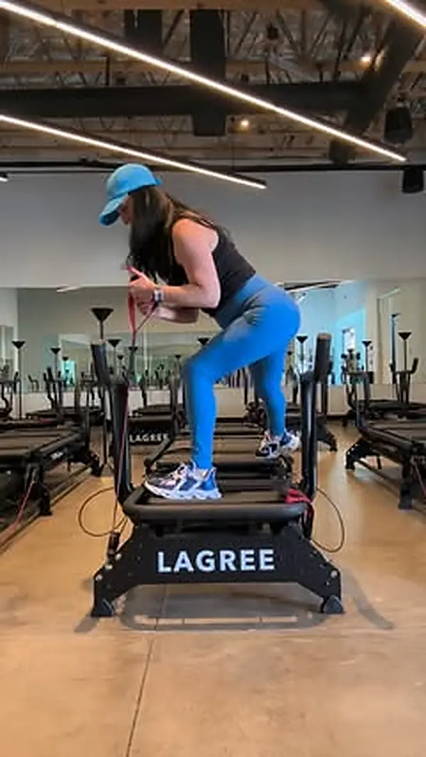 Client mid-set on the Megaformer during a Lagree class